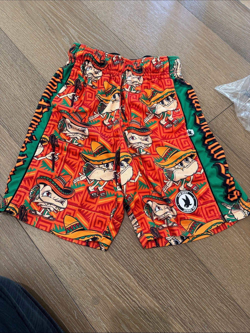 Vibrant Orange Cartoon Print Kids Shorts with Green Accents